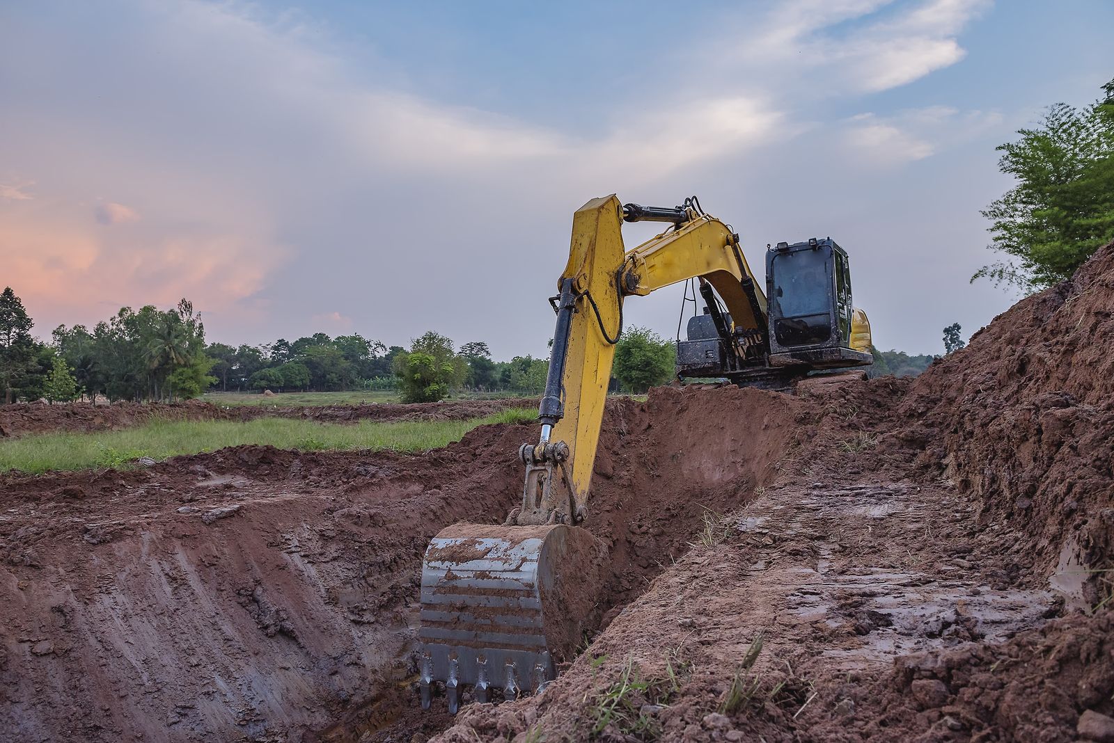View from backhoe was digging a pit in the ground for rainwaterCrawler excavator truck Construction digger machine in flat. Backhoe loader Heavy equipment.
